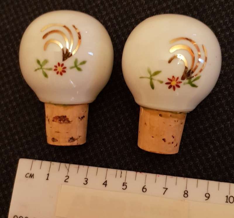 Vintage porcelain bottle stoppers marked Jenever and Rode-Besse.