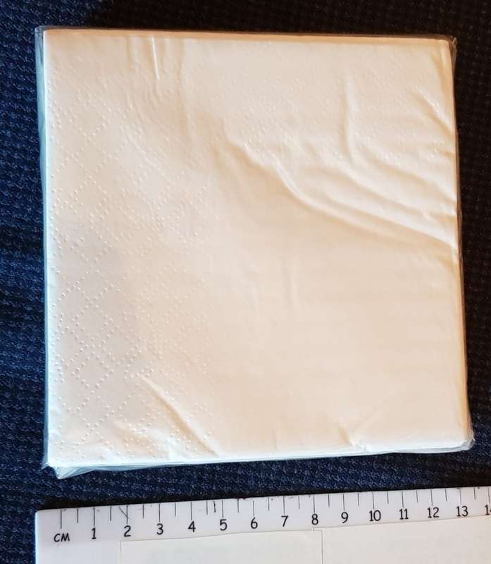 Serviettes: Sealed packet of white drinks serviettes branded Amstel in gold lettering.