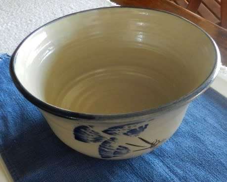Vintage Handmade pottery bowl.   Grey shaded pottery with hand painted blue flower.