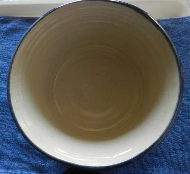 Vintage Handmade pottery bowl.   Grey shaded pottery with hand painted blue flower.
