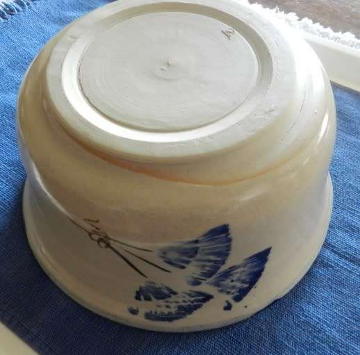 Vintage Handmade pottery bowl.   Grey shaded pottery with hand painted blue flower.