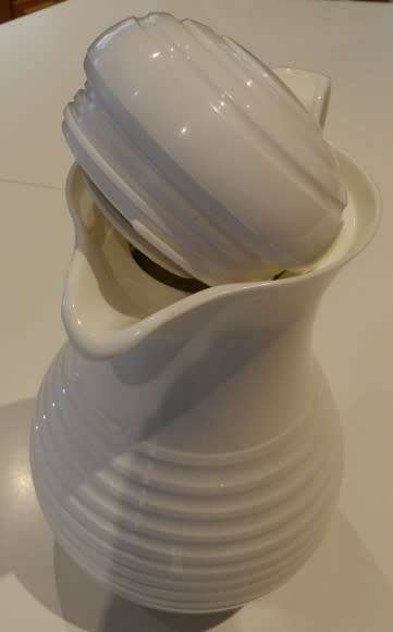 White cold/hot water jug with handle and insulated glass lined interior.