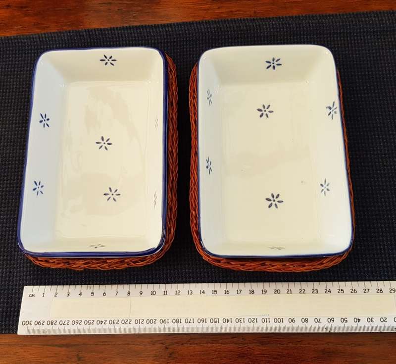 Ceramic small rectangular serving dishes in fitted basket.