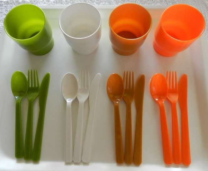 Plastic Picnic cutlery and tumbler set in four colours. White, green, tan and orange.