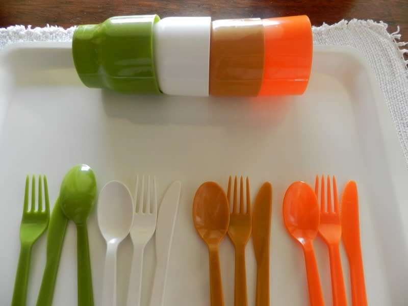 Plastic Picnic cutlery and tumbler set in four colours. White, green, tan and orange.