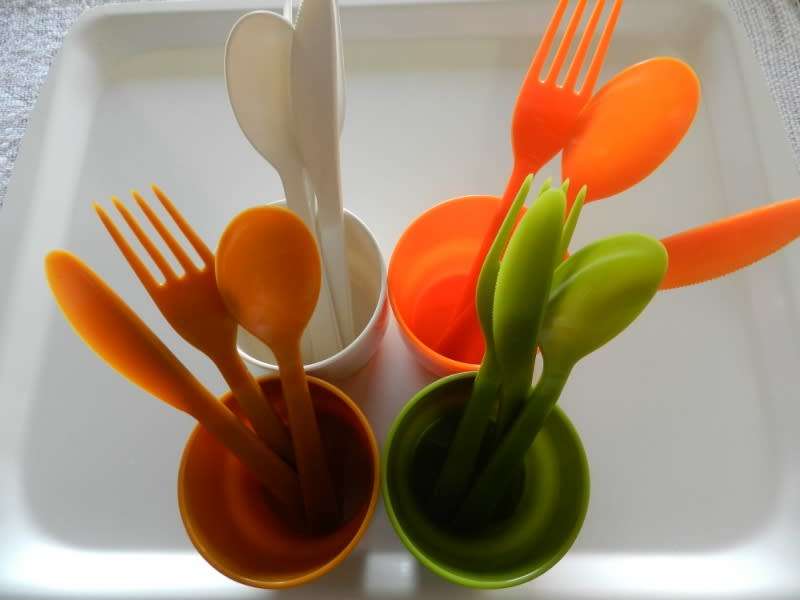 Plastic Picnic cutlery and tumbler set in four colours. White, green, tan and orange.