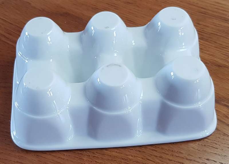 White Novelty porcelain egg holder. Takes 6x Jumbo size eggs.