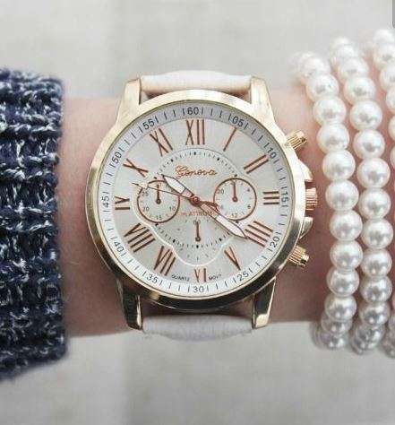 OFF WHITE FACE AND STRAP  GENEVA DIAL GOLD CASE WITH ROMAN NUMERALS  LADIES STUNNING WATCH