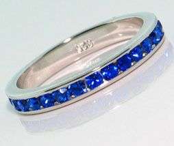 CHANNEL SET BLUE SAPPHIRE CZ ETERNITY RING CRAFTED IN STERLING SILVER