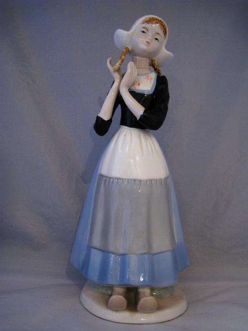 PRETTY PORCELAIN FIGURE OF A DUTCH GIRL WITH PLAITS  26 cm tall.