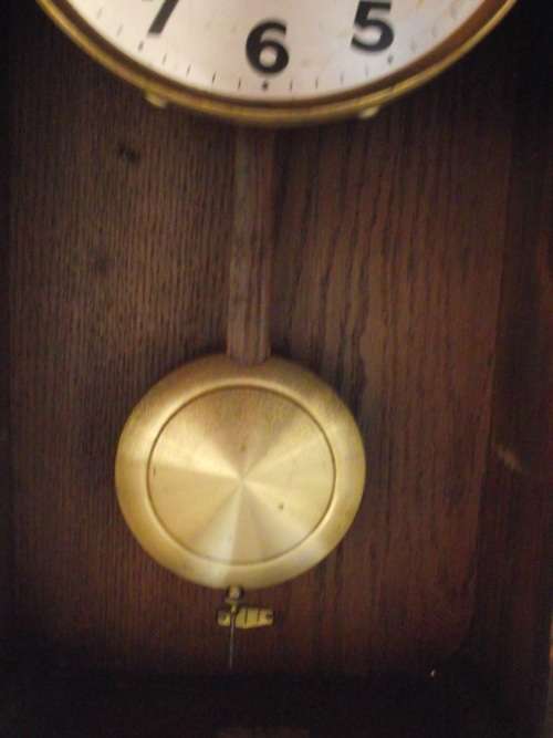 OAK CASED WALL CLOCK IN WORKING CONDITION