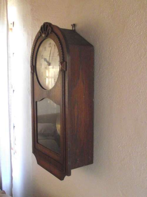 OAK CASED WALL CLOCK IN WORKING CONDITION