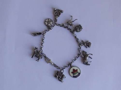 BEAUTIFUL STERLING SILVER CHARM BRACELET WITH 10 ASSORTED CHARMS ATTACHED