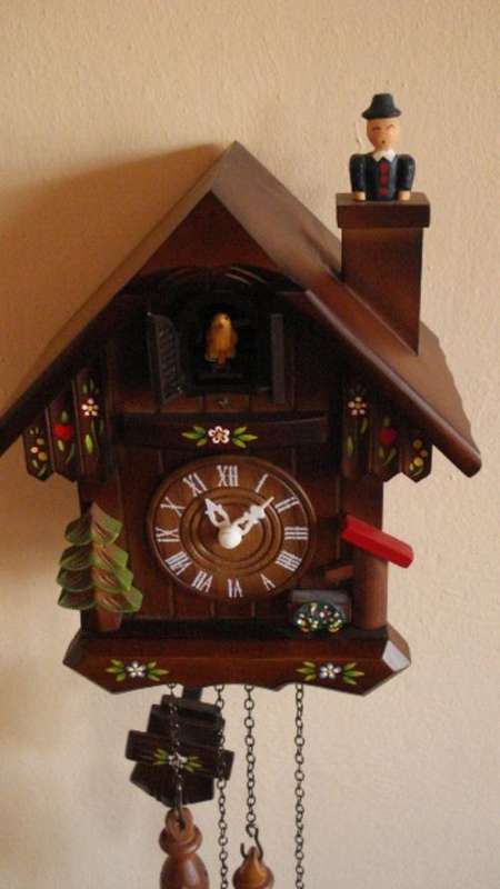 Battery powered cuckoo clock with pine tree