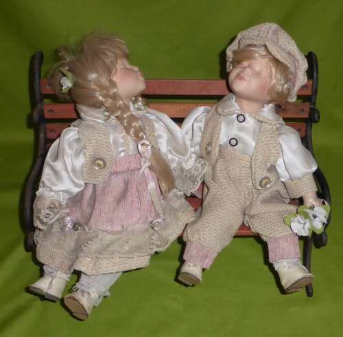 VINTAGE!!! Matching Pair of Pouting Porcelain Dolls on a Very Large Iron and Wood Bench