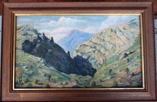 A beautifuIoiI on board depicting a hillside landscape.