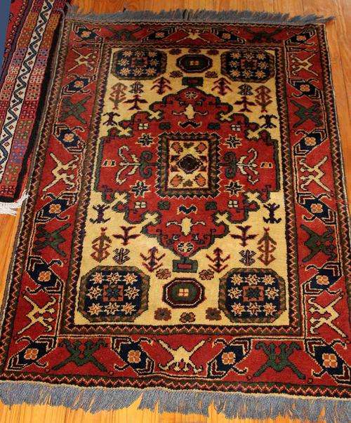 A rare and splendid hand-knotted Kazak rug.