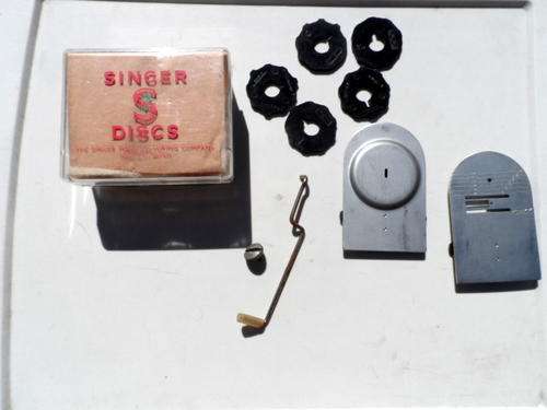 OLD SINGER SEWING MACHINE PARTS WHICH INCLUDES THE BLACK DISCS IN ORIGINAL BOX.