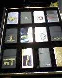 12 X ZIPPO LIGHTERS IN SMART BOOK LIKE CASE AND 10 X DISPLAY CASES. 3 X LADY ZIPPOS