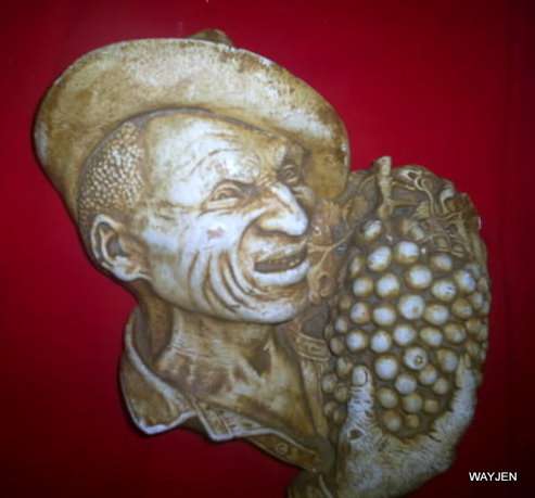 "OU JAPIE" HAND PAINTED SCULPTURE BY A. EMSLEY "JOCK". STAMPED AT BOTTOM. 26cm HIGH WALL HANGING.