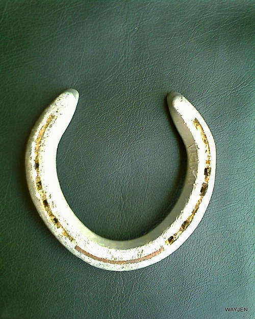 ALUMINIUM HORSESHOE. HORSESHOES ARE BELIEVED TO BE PROTECTORS OF BUILDINGS. THESE ARE WELL WORN.