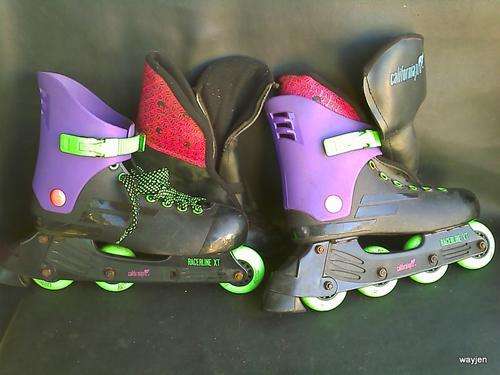 CALIFORNIAPRO. RACELINE XT ROLLER BLADES.PROTECTIVE BOOTIES INCLUDED. NOTE WHEEL MISSING AND 1 LACE.