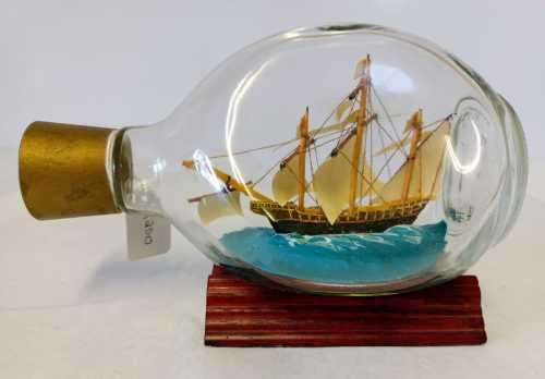 `SANTA MARIA` SHIP IN A BOTTLE FROM THE QUORN RANGE OF MODEL SHIPS on a wooden stand.