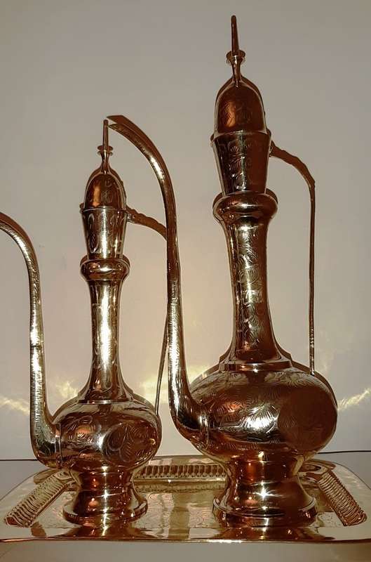 TWO LARGE BRASS DALLAH / SARNA / INDIAN TEAPOTS ON ORNATE BRASS TRAY