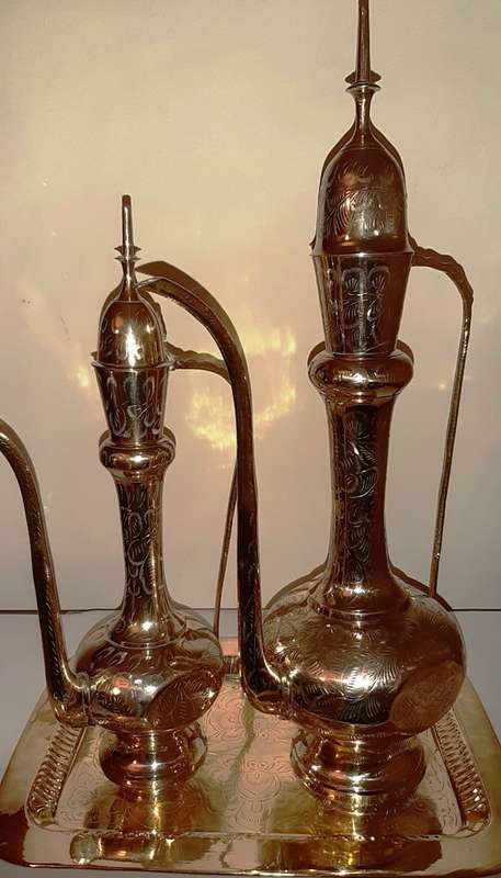 TWO LARGE BRASS DALLAH / SARNA / INDIAN TEAPOTS ON ORNATE BRASS TRAY