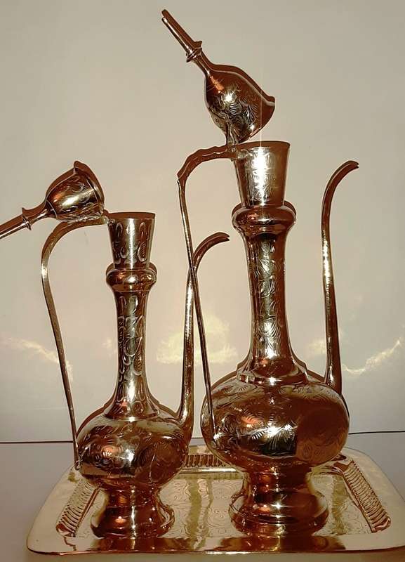 TWO LARGE BRASS DALLAH / SARNA / INDIAN TEAPOTS ON ORNATE BRASS TRAY