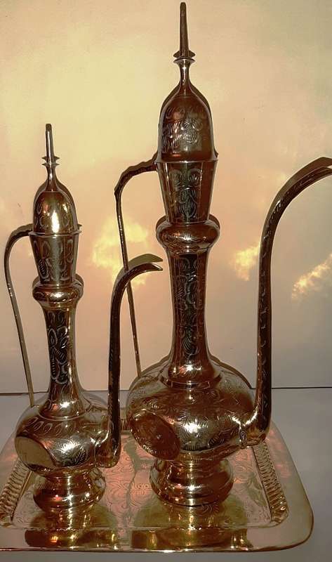 TWO LARGE BRASS DALLAH / SARNA / INDIAN TEAPOTS ON ORNATE BRASS TRAY