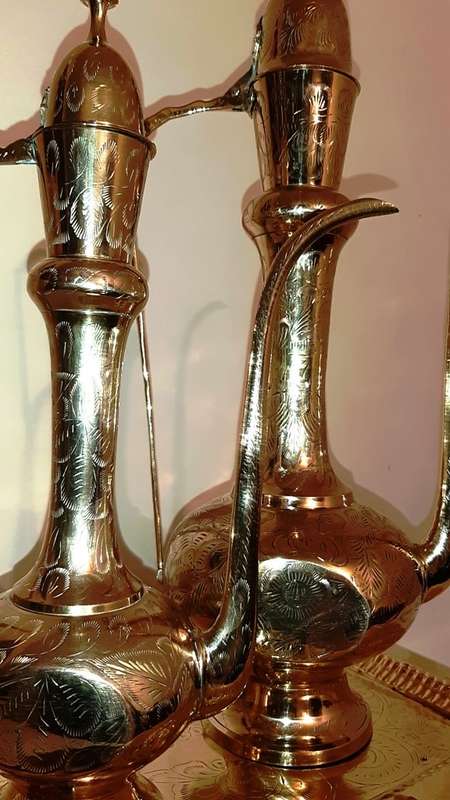 TWO LARGE BRASS DALLAH / SARNA / INDIAN TEAPOTS ON ORNATE BRASS TRAY