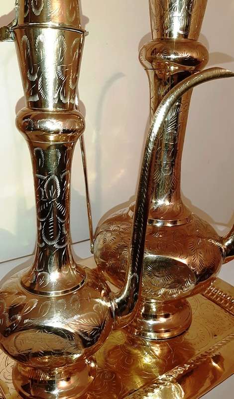 TWO LARGE BRASS DALLAH / SARNA / INDIAN TEAPOTS ON ORNATE BRASS TRAY