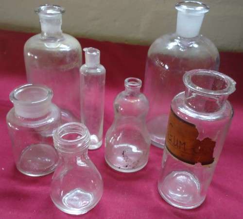 SEVEN DIFFERENT ROUND CLEAR VINTAGE CHEMIST-APOTHECARY BOTTLES-SEE PHOTOS