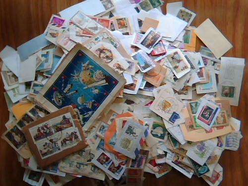 A BOX FULL OF STAMPS ON PAPER 1000's THE WHOLE WORLD