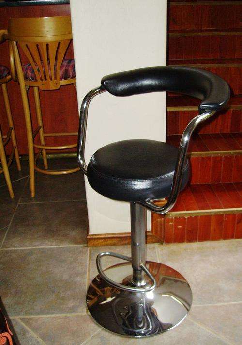 Four black leather bar chairs with chrome finishing