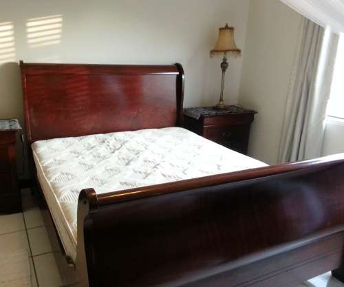 Sleigh bed, queen size with mattress. Side tables, bedding or decor not included