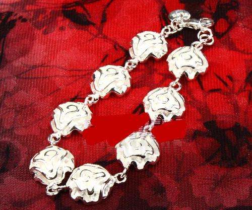 GORGEOUS 8 SILVER ROSES BRACELET 20CM