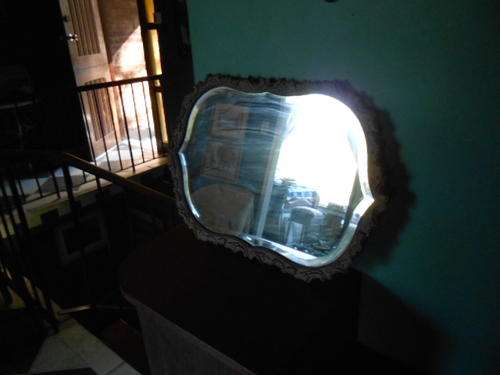BEVILLED MIRROR IN ORNATE FRAME.
