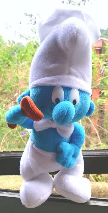 A delightful rare 'Cooking Smurf' plush toy.  24cm.