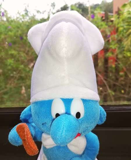 A delightful rare 'Cooking Smurf' plush toy.  24cm.