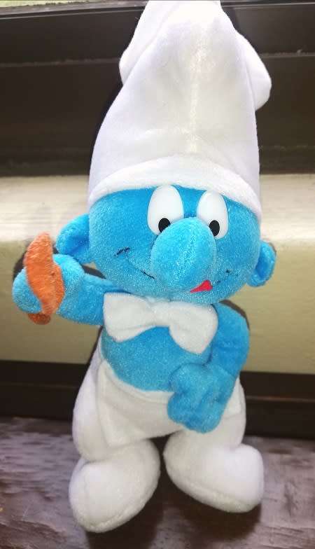 A delightful rare 'Cooking Smurf' plush toy.  24cm.