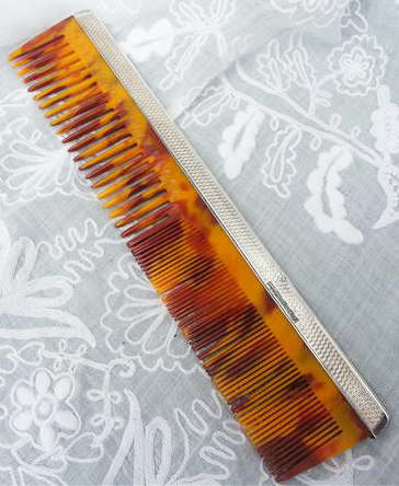 ENGLISH MADE, 1948 TORTOISE SHELL CELLULOID COMB WITH HALL MARKED SILVER TOPPING