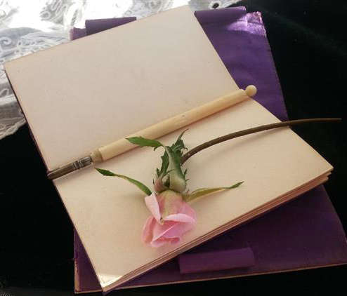 ANTIQUE  IVORY CASED NOTEBOOK AND PENCIL,  FRONT COVER DECORATED WITH WHEAT AND FIELD FLOWERS