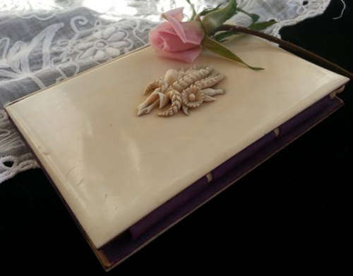 ANTIQUE  IVORY CASED NOTEBOOK AND PENCIL,  FRONT COVER DECORATED WITH WHEAT AND FIELD FLOWERS
