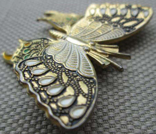 VINTAGE "BRASS" BUTTERFLY WITH A ROLL OVER CLASP.