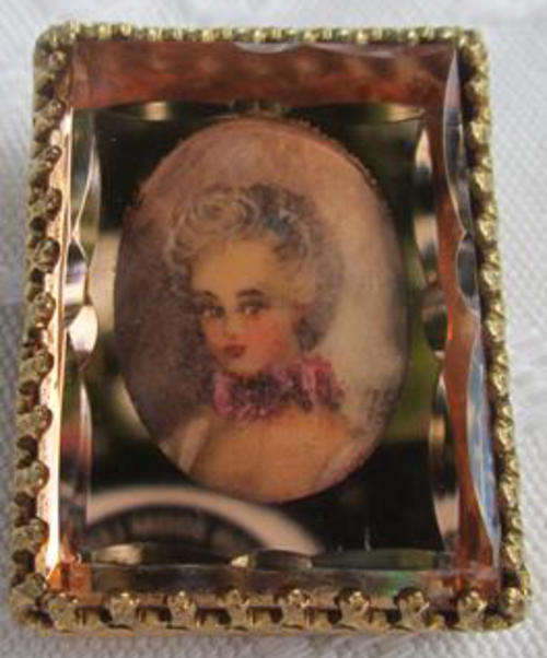 ANTIQUE, MINIATURE PORTRAIT BROOCH SET BEHIND BEVELLED GLASS ALL FRAMED WITH FILLIGREE BRASS..