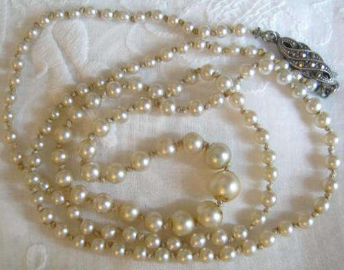 DAINTY FAUX PEARL NECKLACE WITH A STERLING SILVER AND MARCASITE CLASP.