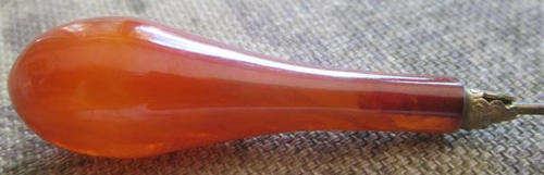 ANTIQUE,  HAT PIN COULD BE AMBER ? BUT MORE LIKELY TO BE CELLULOID, PRETTY !!.