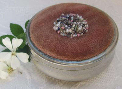 VINTAGE NICKEL SILVER PIN HOLDER WITH DUSTY PINK VELVET AND BEADED DETAIL TO THE LID.